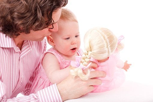 Father And Child Bonding Over A Doll